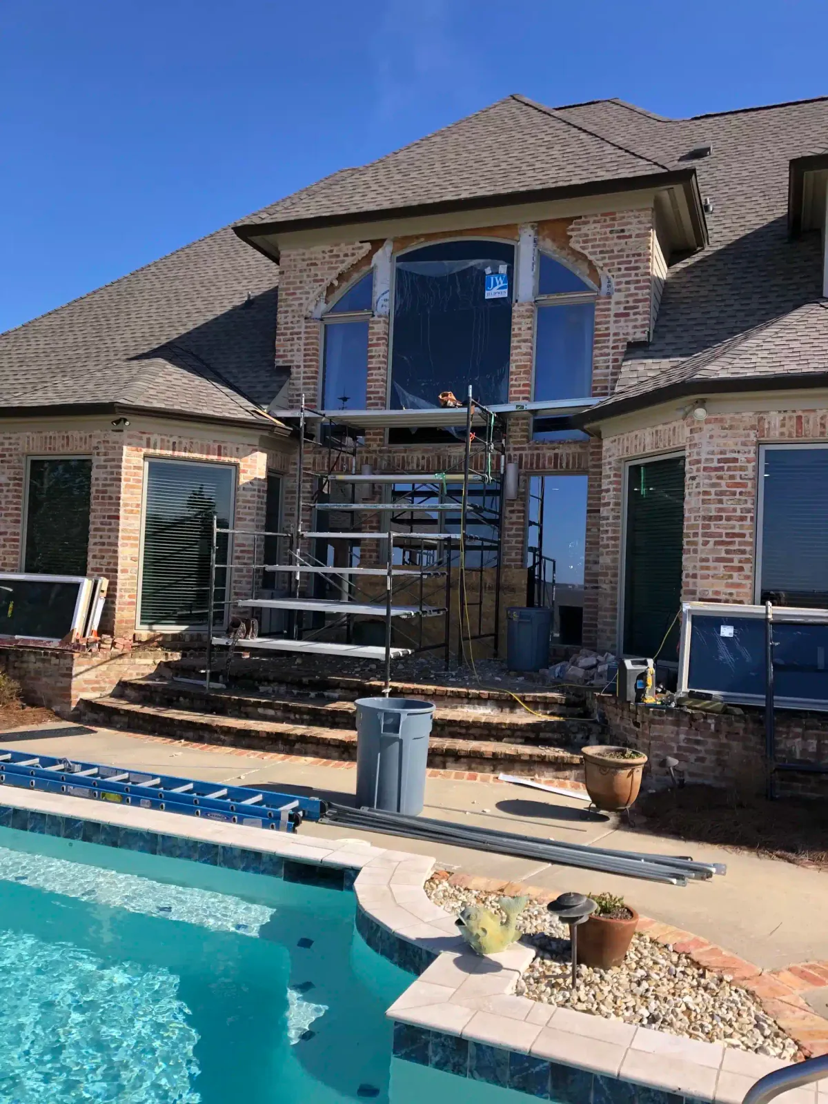 Before: scaffolding over the pool while the tall arched window is replaced