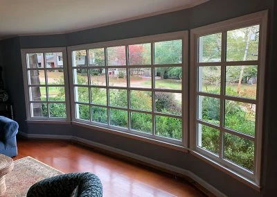 Interior view of a new bay window with divided lights overlooking the garden
