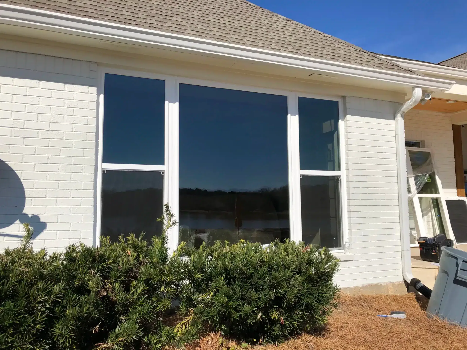 White brick home with new large picture windows installed